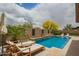Inviting private pool with lounge chairs, landscaping, and blue water at 12031 S 184Th Ave, Goodyear, AZ 85338