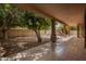 Inviting backyard oasis with a covered patio, mature trees, and a view of the sparkling pool at 1211 W Hawken Way, Chandler, AZ 85286