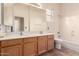 Bathroom featuring double sinks, tile flooring, a large mirror, and plenty of natural light at 1211 W Hawken Way, Chandler, AZ 85286