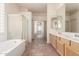 Spacious bathroom with double sink vanity, walk-in shower, and a soaking tub at 1211 W Hawken Way, Chandler, AZ 85286