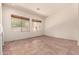 Bedroom with tiled floors, neutral walls, and natural light from two windows at 1211 W Hawken Way, Chandler, AZ 85286