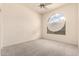 Bedroom features carpet flooring and a uniquely arched window with modern blinds at 1211 W Hawken Way, Chandler, AZ 85286