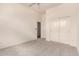 Bright bedroom features plush carpeting, neutral walls, and a closet with bi-fold doors at 1211 W Hawken Way, Chandler, AZ 85286