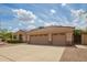 Charming single-story home with a three-car garage, wide driveway, and xeriscaping at 1211 W Hawken Way, Chandler, AZ 85286