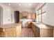 Kitchen with stainless appliances, wood cabinets, center island, and lots of natural light at 1211 W Hawken Way, Chandler, AZ 85286