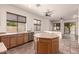 Eat-in kitchen with wood cabinetry, stainless appliances, and tile flooring flowing into living space at 1211 W Hawken Way, Chandler, AZ 85286