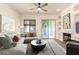 Bright living room featuring a ceiling fan, fireplace, large windows, and neutral decor at 1211 W Hawken Way, Chandler, AZ 85286