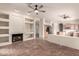 Open-concept living space featuring tiled floors, fireplace, built-in shelving, and access to the kitchen at 1211 W Hawken Way, Chandler, AZ 85286