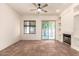 A bright living room features tile flooring, recessed lighting, a fireplace, and glass slider at 1211 W Hawken Way, Chandler, AZ 85286