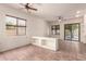 Spacious living room with tiled flooring, ceiling fan, and plenty of natural light at 1211 W Hawken Way, Chandler, AZ 85286