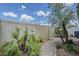 Lush backyard with a paver pathway, palm trees, and a privacy fence, creating a serene outdoor escape at 1367 S Country Club Dr # 1189, Mesa, AZ 85210