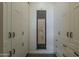 Hallway closet featuring white cabinets with modern hardware and decor at 1367 S Country Club Dr # 1189, Mesa, AZ 85210