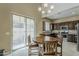 Dining area and kitchen featuring wooden table and chairs and large window and slider at 1367 S Country Club Dr # 1189, Mesa, AZ 85210