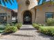 Elegant building entrance with arched doorway, beautiful landscaping, and a paver walkway, creating a welcoming approach at 1367 S Country Club Dr # 1189, Mesa, AZ 85210