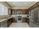 Stylish kitchen boasting stainless steel appliances, generous counter space, and dark wood cabinets at 1367 S Country Club Dr # 1189, Mesa, AZ 85210