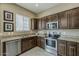 Modern kitchen featuring granite countertops, stainless steel appliances and dark wood cabinetry at 1367 S Country Club Dr # 1189, Mesa, AZ 85210