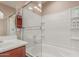 Cozy bathroom featuring a shower and bathtub with a sliding glass door at 14239 W Port Royale Ln, Surprise, AZ 85379