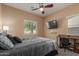 Functional bedroom featuring a workstation and a wall-mounted TV at 14239 W Port Royale Ln, Surprise, AZ 85379
