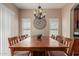 Dining room with large wood table, seating for eight, and modern light fixture at 14239 W Port Royale Ln, Surprise, AZ 85379