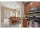Open-concept kitchen with dining area featuring modern chandelier and seating for eight at 14239 W Port Royale Ln, Surprise, AZ 85379