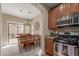 Open-concept kitchen with dining area featuring modern chandelier and seating for eight at 14239 W Port Royale Ln, Surprise, AZ 85379