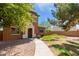 Home exterior featuring drought-tolerant landscaping, walkway, and neutral-toned stucco at 14239 W Port Royale Ln, Surprise, AZ 85379