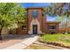 Charming two-story home featuring a desert landscape, neutral-tone paint, and inviting entryway at 14239 W Port Royale Ln, Surprise, AZ 85379