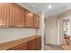 Hallway includes built-in cabinets with a countertop and an arched doorway at 14239 W Port Royale Ln, Surprise, AZ 85379