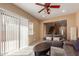 Bright living room with sliding glass doors and views into the open floor plan at 14239 W Port Royale Ln, Surprise, AZ 85379