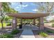 Covered picnic area with tables and grills, surrounded by landscaping at 14239 W Port Royale Ln, Surprise, AZ 85379