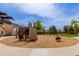 Community playground with climbing structure, swings, and a seesaw at 14239 W Port Royale Ln, Surprise, AZ 85379