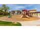 Playground featuring slides, swings and climbing structure with community homes nearby at 14239 W Port Royale Ln, Surprise, AZ 85379