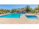 Gorgeous community pool and hot tub with lounge seating and a restroom facility at 14239 W Port Royale Ln, Surprise, AZ 85379