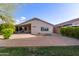 Backyard features pavers, desert landscaping, covered patio, offering a low-maintenance outdoor living space at 14722 W Lucas Ln, Surprise, AZ 85374