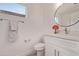 Modern half bathroom with a large mirror, white vanity and brushed nickel fixtures at 14722 W Lucas Ln, Surprise, AZ 85374