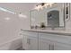 Bathroom featuring double sinks, white cabinets, and tub at 14722 W Lucas Ln, Surprise, AZ 85374