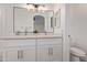 Bathroom featuring double sinks, white cabinets, and fixtures at 14722 W Lucas Ln, Surprise, AZ 85374