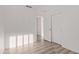 Empty bedroom with wood-look flooring and closet at 14722 W Lucas Ln, Surprise, AZ 85374