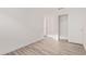 An empty bedroom with wood-look flooring and a closet at 14722 W Lucas Ln, Surprise, AZ 85374