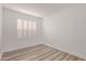 Bright bedroom features wood-look flooring and plantation shutters at 14722 W Lucas Ln, Surprise, AZ 85374