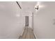 Bright hallway featuring wood-look flooring and white walls at 14722 W Lucas Ln, Surprise, AZ 85374