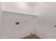 An interior view of the laundry room with shelving at 14722 W Lucas Ln, Surprise, AZ 85374