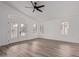 Bright living room featuring wood-look flooring, vaulted ceiling and French doors to the backyard at 14722 W Lucas Ln, Surprise, AZ 85374