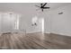 Bright living room featuring wood-look flooring, white walls and an open floor plan to the kitchen at 14722 W Lucas Ln, Surprise, AZ 85374