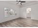Spacious primary bedroom with wood-look floors and ensuite bathroom at 14722 W Lucas Ln, Surprise, AZ 85374