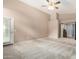 Spacious bedroom with neutral carpet, high ceilings, and a door leading to another room at 15328 W Memory Ln, Surprise, AZ 85374