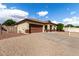 Charming single-story home showcasing a tile roof, desert landscaping, and a spacious driveway at 15328 W Memory Ln, Surprise, AZ 85374
