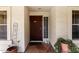 Charming front porch with security screen door, potted plants, and textured stucco at 15328 W Memory Ln, Surprise, AZ 85374