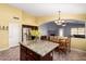 Bright kitchen with granite countertops, stainless steel refrigerator, and an island for entertaining at 15328 W Memory Ln, Surprise, AZ 85374