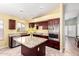 Well-equipped kitchen with stainless steel appliances, granite countertops, and dark wood cabinets at 15328 W Memory Ln, Surprise, AZ 85374